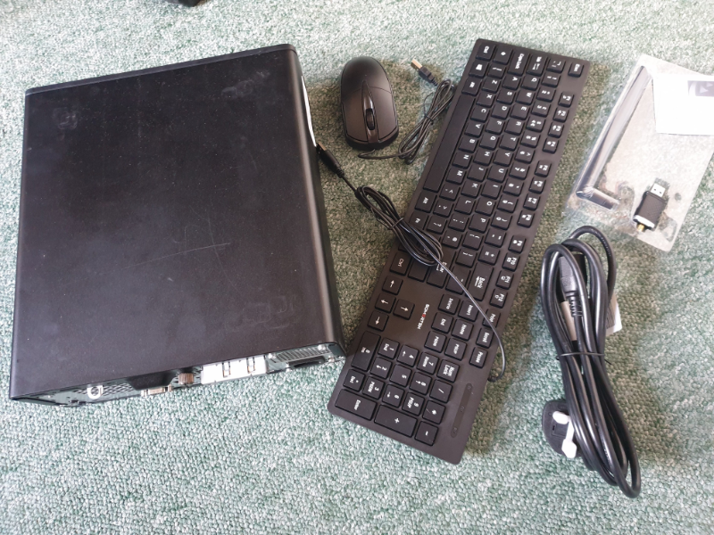 scuffed black metallic box, keyboard, mouse etc